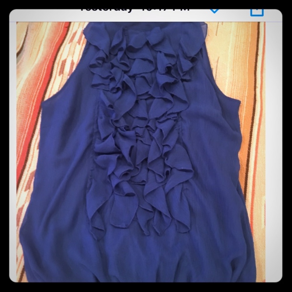 Royal blue sleeveless ruffle shirt.